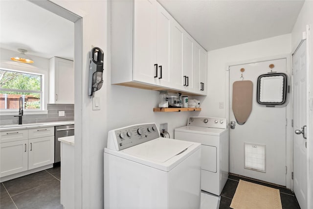 2744 Bay Meadows Ct, Farmers Branch, TX 75234 - washroom with cabinet space, washing machine and dryer, and dark tile patterned flooring