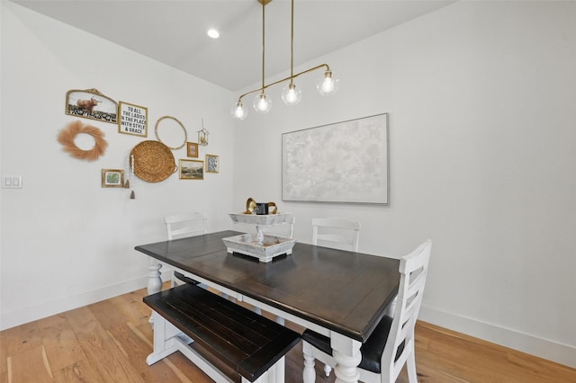 dining room featuring baseboards and light wood-style flooring