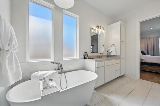 1109 Mountain View Dr, Weatherford, TX 76087 - full bath featuring a freestanding bath, vanity, tile patterned floors, and connected bathroom