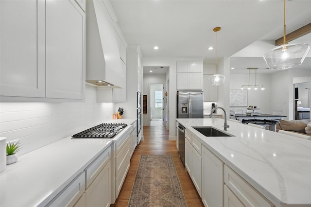 kitchen with decorative backsplash, custom exhaust hood, recessed lighting, a sink, and appliances with stainless steel finishes