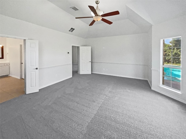 unfurnished bedroom featuring carpet, lofted ceiling, visible vents, baseboards, and ceiling fan