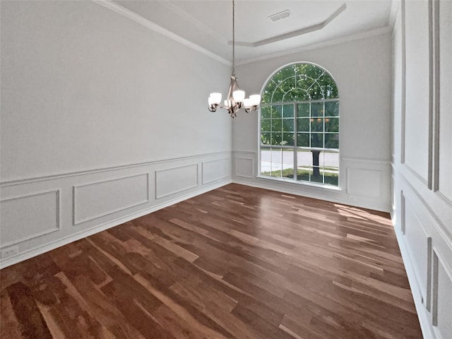 unfurnished dining area with dark wood-style floors, visible vents, an inviting chandelier, a decorative wall, and ornamental molding