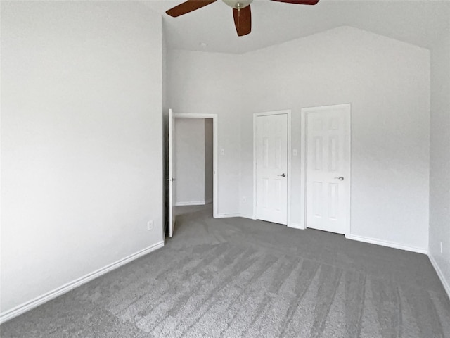 unfurnished bedroom featuring vaulted ceiling, baseboards, carpet floors, and ceiling fan