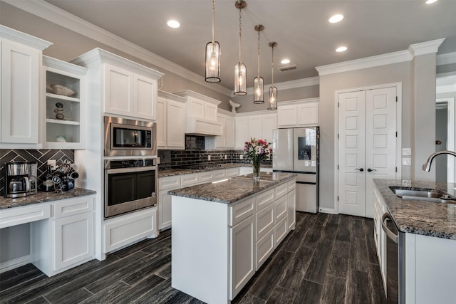 5124 Cathedral Ln, Wichita Falls, TX 76310 - kitchen featuring a sink, a kitchen island with sink, white cabinets, appliances with stainless steel finishes, and dark wood-type flooring
