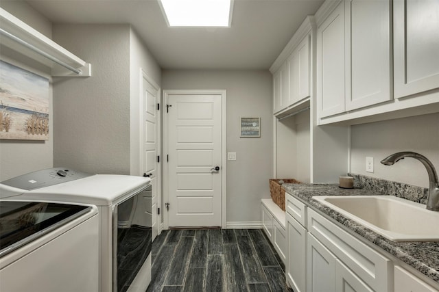 5124 Cathedral Ln, Wichita Falls, TX 76310 - clothes washing area with a sink, washing machine and dryer, baseboards, cabinet space, and dark wood-style flooring