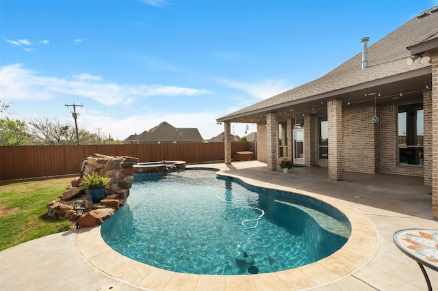 5124 Cathedral Ln, Wichita Falls, TX 76310 - view of swimming pool featuring a pool with connected hot tub, a patio, and a fenced backyard