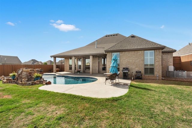 5124 Cathedral Ln, Wichita Falls, TX 76310 - rear view of house featuring brick siding, a patio area, a lawn, a fenced backyard, and roof with shingles