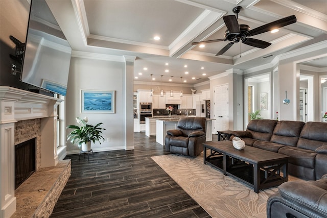 5124 Cathedral Ln, Wichita Falls, TX 76310 - living area with ceiling fan, a fireplace with raised hearth, ornamental molding, baseboards, and dark wood-style flooring