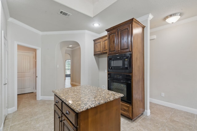 kitchen featuring visible vents, arched walkways, black appliances, and crown molding