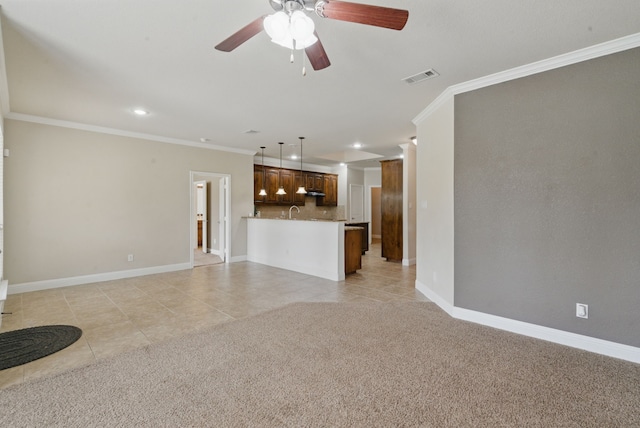 unfurnished living room with visible vents, baseboards, and ornamental molding