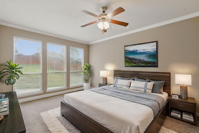 bedroom featuring ceiling fan, baseboards, crown molding, and carpet flooring