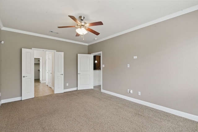 unfurnished bedroom with baseboards, visible vents, light colored carpet, ceiling fan, and crown molding