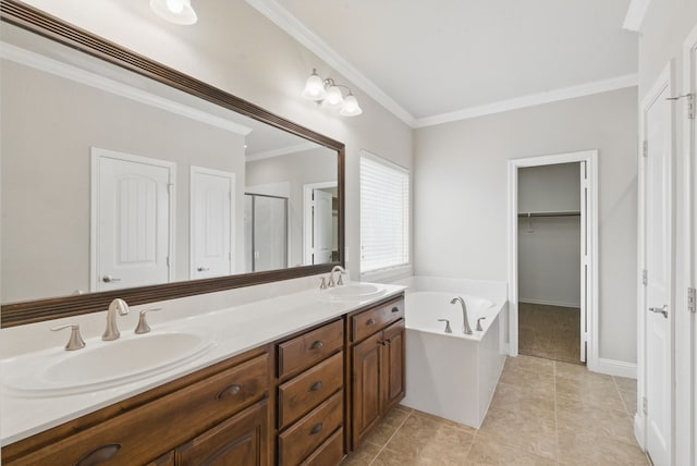 full bathroom with double vanity, a garden tub, ornamental molding, and a sink