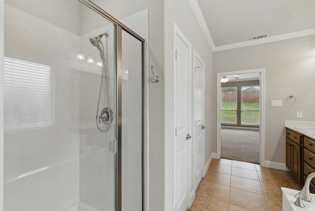 bathroom with tile patterned floors, visible vents, a shower stall, vanity, and ornamental molding