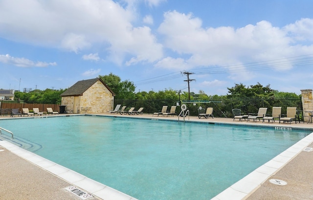pool with fence and a patio area
