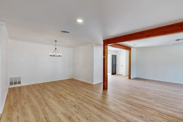 unfurnished dining area featuring light wood finished floors, visible vents, and a chandelier