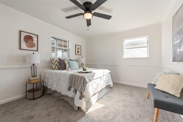 carpeted bedroom with baseboards, crown molding, and multiple windows