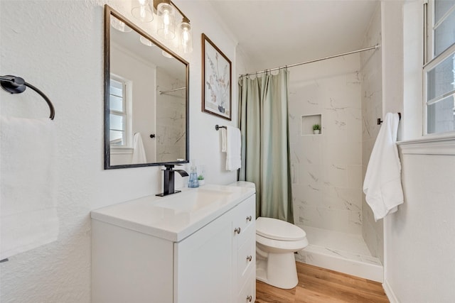 full bath with vanity, wood finished floors, a shower stall, and toilet