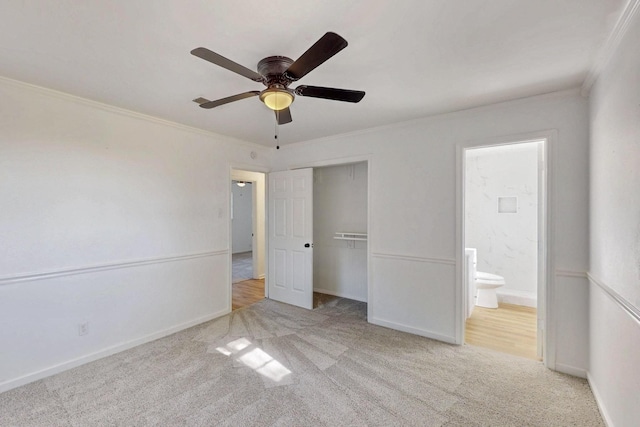 unfurnished bedroom featuring carpet, a closet, crown molding, and baseboards