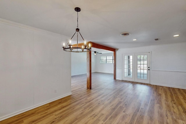 unfurnished dining area featuring a chandelier, wood finished floors, and visible vents
