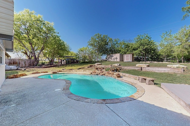 view of swimming pool featuring a fenced in pool, a patio area, an outdoor structure, a yard, and a shed