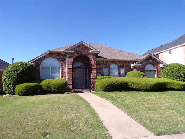 315 Rain Tree Dr, Sunnyvale, TX 75182 - view of front of property featuring brick siding, roof with shingles, and a front lawn