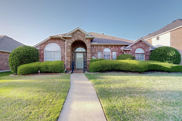315 Rain Tree Dr, Sunnyvale, TX 75182 - view of front of house with brick siding, roof with shingles, and a front lawn