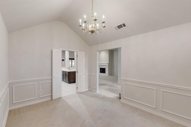 315 Rain Tree Dr, Sunnyvale, TX 75182 - spare room featuring a chandelier, a decorative wall, a sink, a wainscoted wall, and light colored carpet