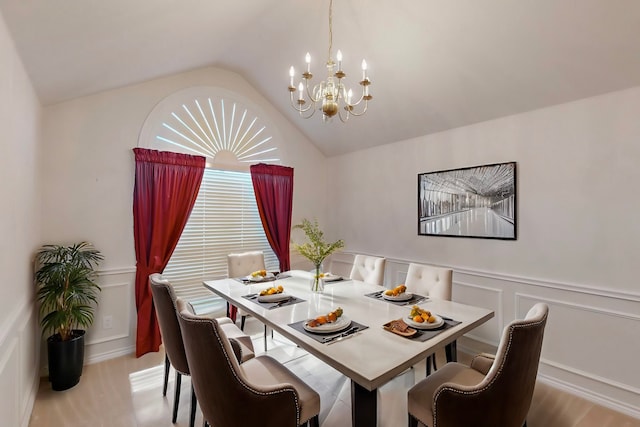 315 Rain Tree Dr, Sunnyvale, TX 75182 - dining space with a chandelier, wood finished floors, lofted ceiling, a decorative wall, and wainscoting
