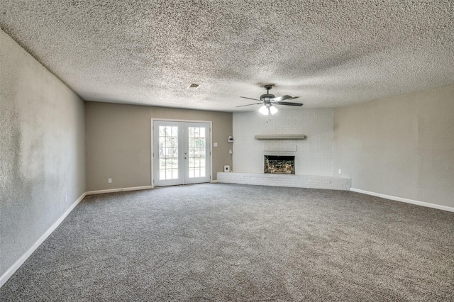 unfurnished living room featuring a ceiling fan, a fireplace, baseboards, carpet flooring, and visible vents