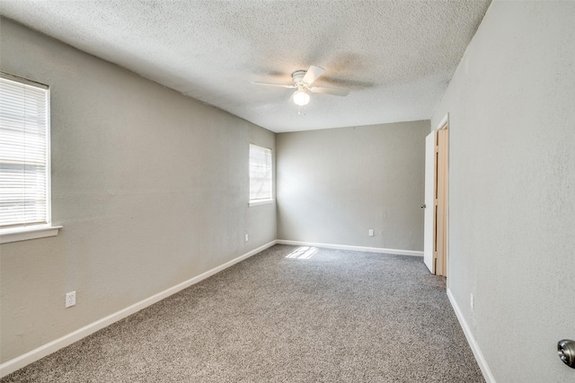 empty room featuring carpet floors, a textured ceiling, and a ceiling fan