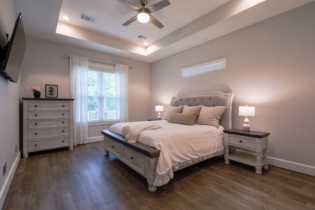bedroom with baseboards, dark wood-type flooring, and visible vents