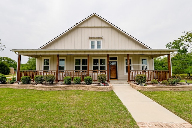 farmhouse with board and batten siding, a porch, and a front yard