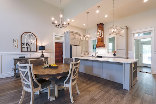 kitchen featuring light countertops, freestanding refrigerator, a chandelier, and a spacious island