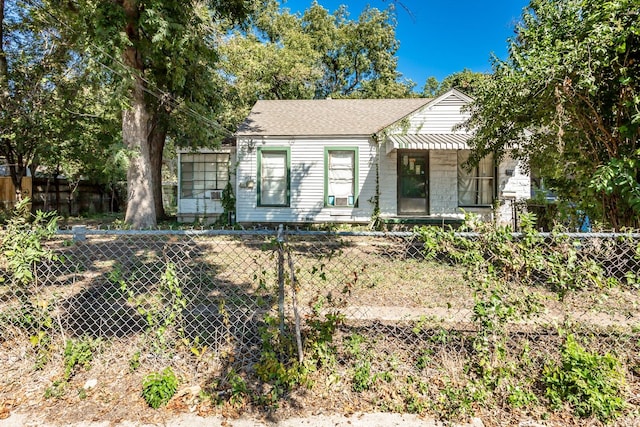 5663 Cary St, Dallas, TX 75227 - bungalow-style house featuring roof with shingles and a fenced front yard