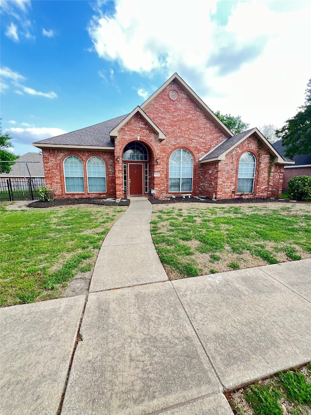 2210 Fairlands Dr, Garland, TX 75040 - ranch-style home featuring brick siding, roof with shingles, a front lawn, and fence