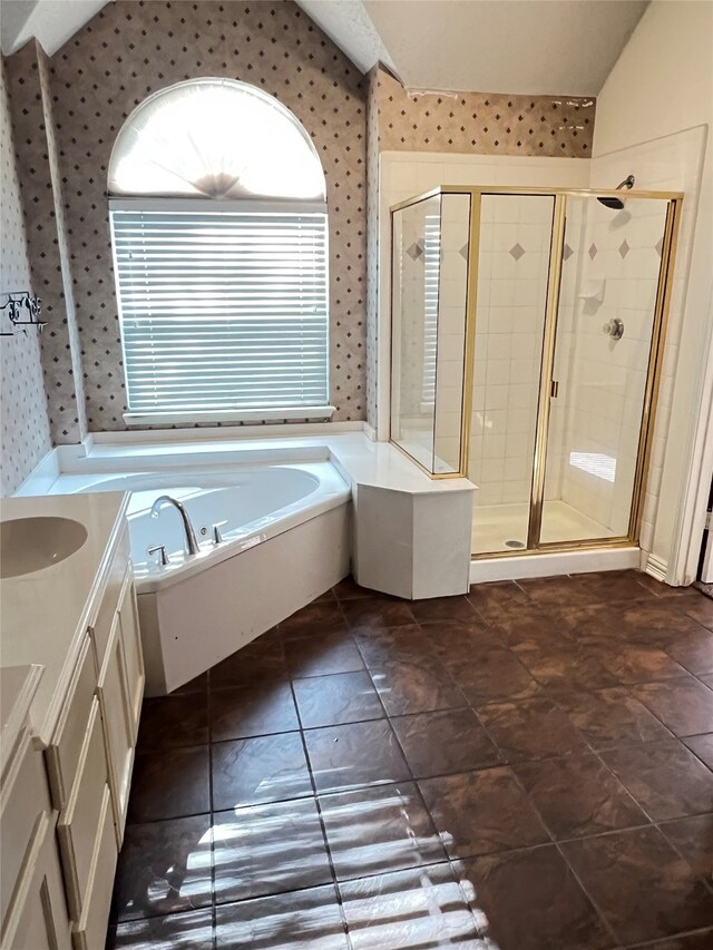 2210 Fairlands Dr, Garland, TX 75040 - bathroom featuring wallpapered walls, a shower stall, vaulted ceiling, vanity, and a bath