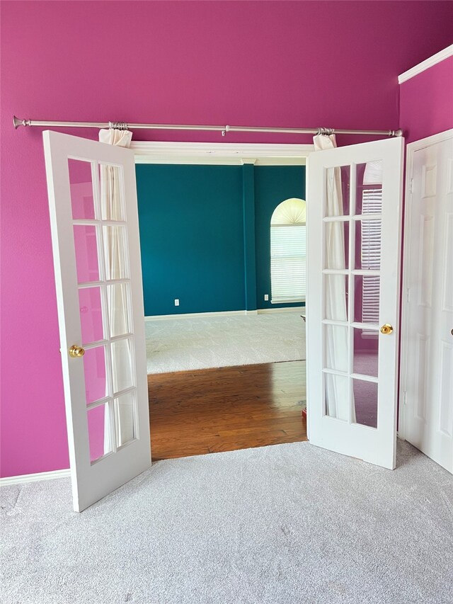 2210 Fairlands Dr, Garland, TX 75040 - spare room with french doors, wood finished floors, and carpet floors
