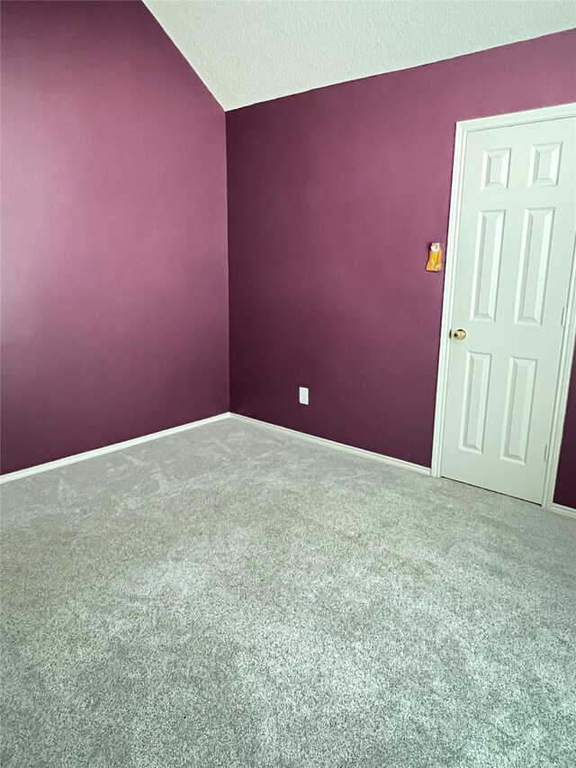 2210 Fairlands Dr, Garland, TX 75040 - carpeted empty room with lofted ceiling, a textured ceiling, and baseboards