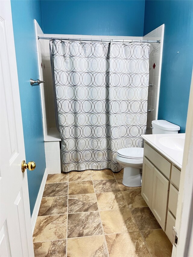 2210 Fairlands Dr, Garland, TX 75040 - bathroom featuring stone finish flooring, toilet, vanity, and shower / bath combo with shower curtain