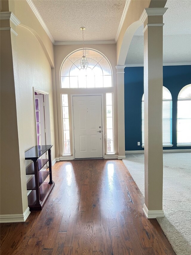 2210 Fairlands Dr, Garland, TX 75040 - entryway featuring a wealth of natural light, arched walkways, a textured ceiling, and ornate columns