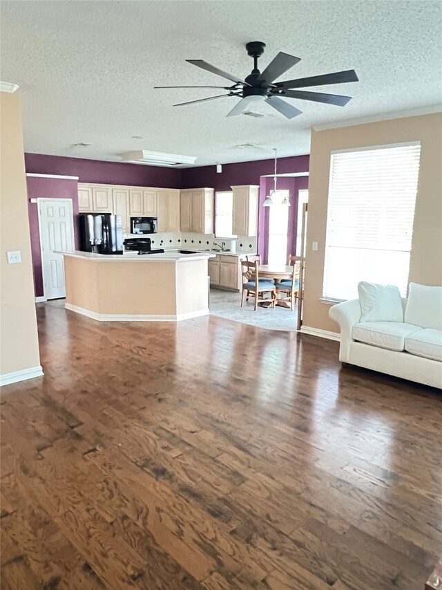 2210 Fairlands Dr, Garland, TX 75040 - living area with dark wood-type flooring, a textured ceiling, a ceiling fan, and baseboards