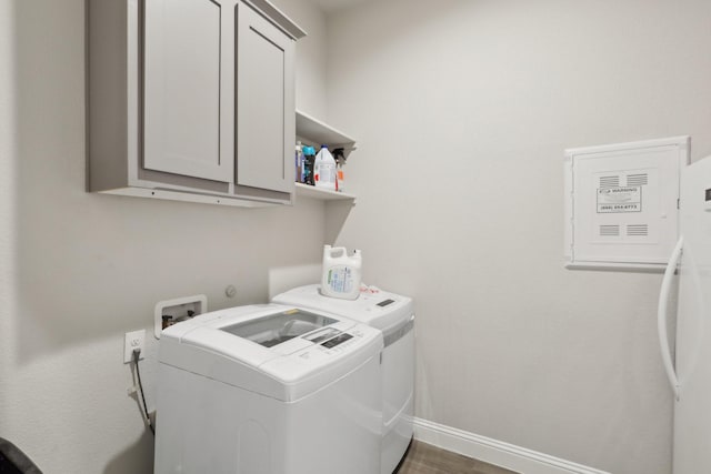 3651 Rainwater Trl, Grand Prairie, TX 76065 - washroom with cabinet space, washing machine and dryer, baseboards, and dark wood-style flooring