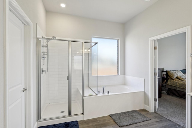 3651 Rainwater Trl, Grand Prairie, TX 76065 - ensuite bathroom with a shower stall, a bath, and wood finished floors