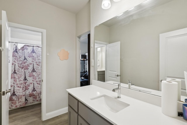 3651 Rainwater Trl, Grand Prairie, TX 76065 - bathroom with wood finished floors, vanity, curtained shower, and baseboards