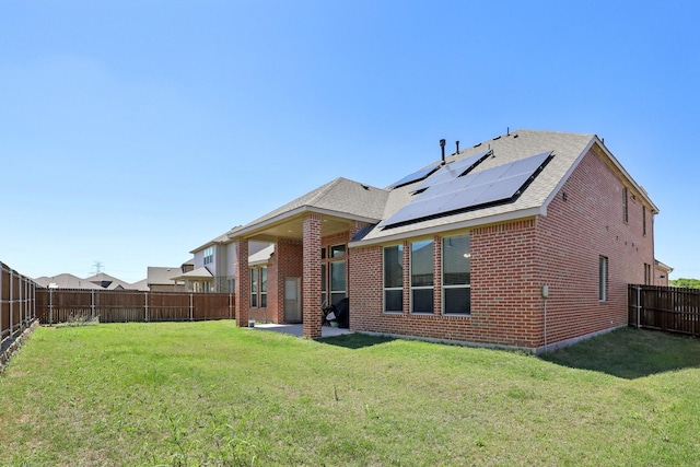 3651 Rainwater Trl, Grand Prairie, TX 76065 - rear view of house featuring brick siding, solar panels, a patio area, and roof with shingles