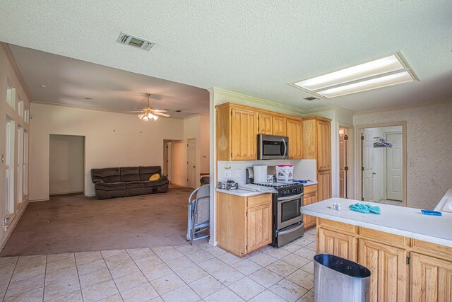 kitchen with light carpet, visible vents, appliances with stainless steel finishes, light countertops, and light tile patterned floors
