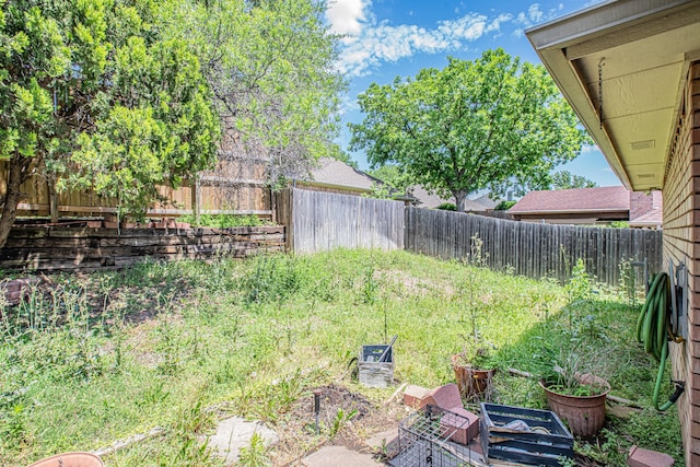 view of yard with a fenced backyard