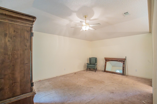 unfurnished room with a ceiling fan, visible vents, and carpet