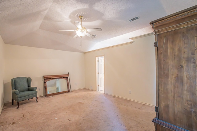 unfurnished room with a textured ceiling, lofted ceiling, visible vents, and ceiling fan